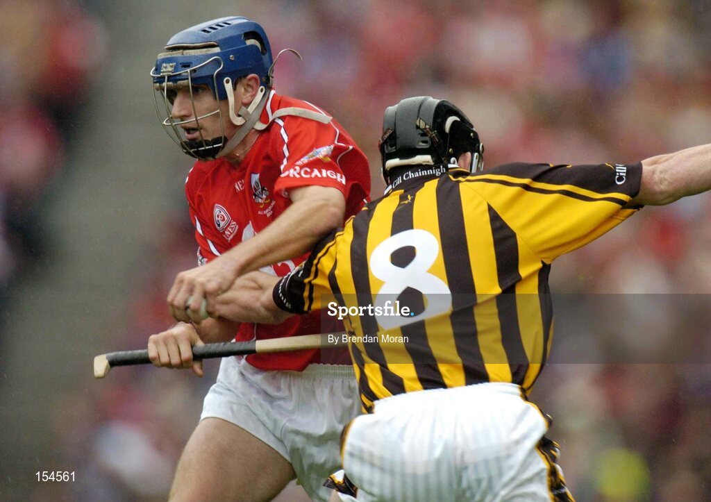 12 September 2004; Tom Kenny, Cork, in action against Derek Lyng, Kilkenny. Guinness All-Ireland Senior Hurling Championship Final, Cork v Kilkenny, Croke Park, Dublin. Picture credit; Brendan Moran / SPORTSFILE *** Local Caption *** Any photograph taken by SPORTSFILE during, or in connection with, the 2004 Guinness All-Ireland Hurling Final which displays GAA logos or contains an image or part of an image of any GAA intellectual property, or, which contains images of a GAA player/players in their playing uniforms, may only be used for editorial and non-advertising purposes.  Use of photographs for advertising, as posters or for purchase separately is strictly prohibited unless prior written approval has been obtained from the Gaelic Athletic Association.