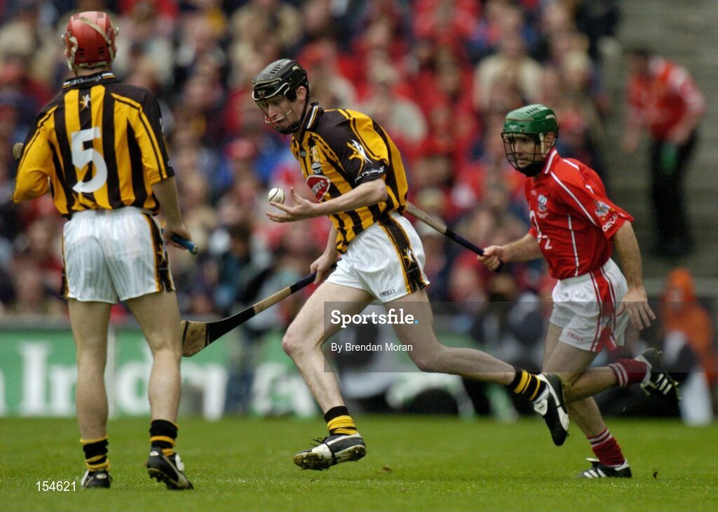 12 September 2004; Martin Comerford, Kilkenny, in action against Jerry O'Connor, Cork. Guinness All-Ireland Senior Hurling Championship Final, Cork v Kilkenny, Croke Park, Dublin. Picture credit; Brendan Moran / SPORTSFILE *** Local Caption *** Any photograph taken by SPORTSFILE during, or in connection with, the 2004 Guinness All-Ireland Hurling Final which displays GAA logos or contains an image or part of an image of any GAA intellectual property, or, which contains images of a GAA player/players in their playing uniforms, may only be used for editorial and non-advertising purposes.  Use of photographs for advertising, as posters or for purchase separately is strictly prohibited unless prior written approval has been obtained from the Gaelic Athletic Association.