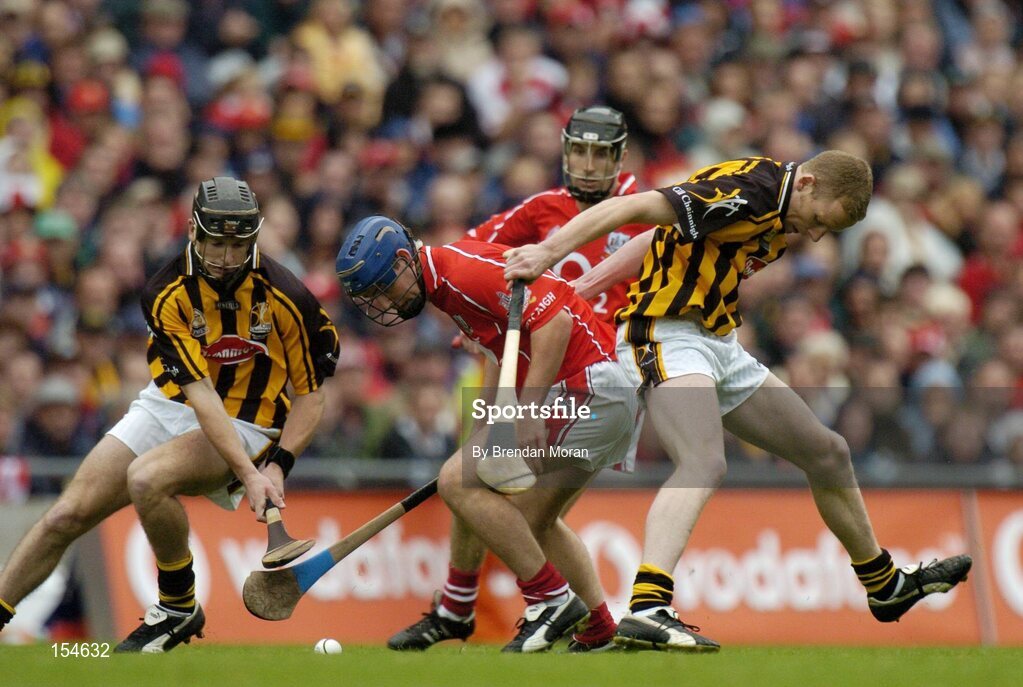 12 September 2004; Kieran Murphy, Cork, in action against JJ Delaney, left, and James Ryall, Kilkenny. Guinness All-Ireland Senior Hurling Championship Final, Cork v Kilkenny, Croke Park, Dublin. Picture credit; Brendan Moran / SPORTSFILE *** Local Caption *** Any photograph taken by SPORTSFILE during, or in connection with, the 2004 Guinness All-Ireland Hurling Final which displays GAA logos or contains an image or part of an image of any GAA intellectual property, or, which contains images of a GAA player/players in their playing uniforms, may only be used for editorial and non-advertising purposes.  Use of photographs for advertising, as posters or for purchase separately is strictly prohibited unless prior written approval has been obtained from the Gaelic Athletic Association.