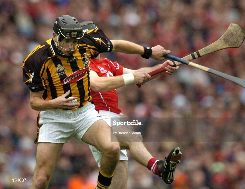 12 September 2004; JJ Delaney, Kilkenny, in action against Ben O'Connor, Cork. Guinness All-Ireland Senior Hurling Championship Final, Cork v Kilkenny, Croke Park, Dublin. Picture credit; Brendan Moran / SPORTSFILE *** Local Caption *** Any photograph taken by SPORTSFILE during, or in connection with, the 2004 Guinness All-Ireland Hurling Final which displays GAA logos or contains an image or part of an image of any GAA intellectual property, or, which contains images of a GAA player/players in their playing uniforms, may only be used for editorial and non-advertising purposes.  Use of photographs for advertising, as posters or for purchase separately is strictly prohibited unless prior written approval has been obtained from the Gaelic Athletic Association.