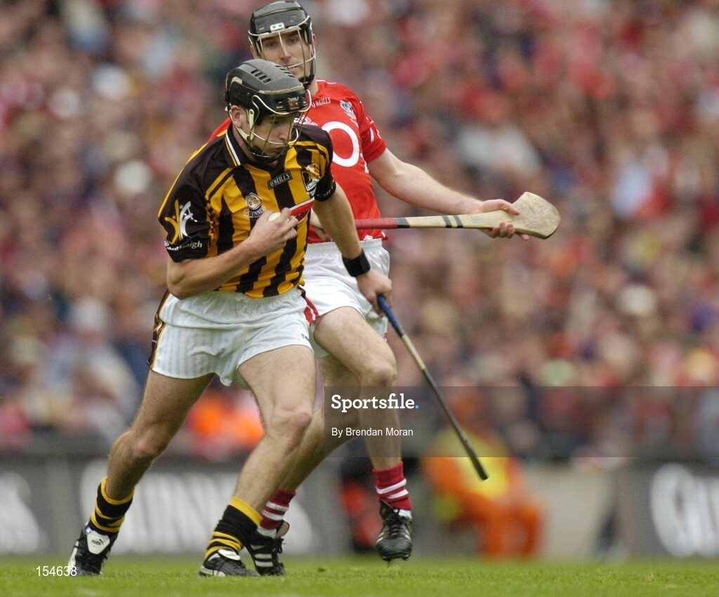 12 September 2004; JJ Delaney, Kilkenny, in action against Ben O'Connor, Cork. Guinness All-Ireland Senior Hurling Championship Final, Cork v Kilkenny, Croke Park, Dublin. Picture credit; Brendan Moran / SPORTSFILE *** Local Caption *** Any photograph taken by SPORTSFILE during, or in connection with, the 2004 Guinness All-Ireland Hurling Final which displays GAA logos or contains an image or part of an image of any GAA intellectual property, or, which contains images of a GAA player/players in their playing uniforms, may only be used for editorial and non-advertising purposes.  Use of photographs for advertising, as posters or for purchase separately is strictly prohibited unless prior written approval has been obtained from the Gaelic Athletic Association.