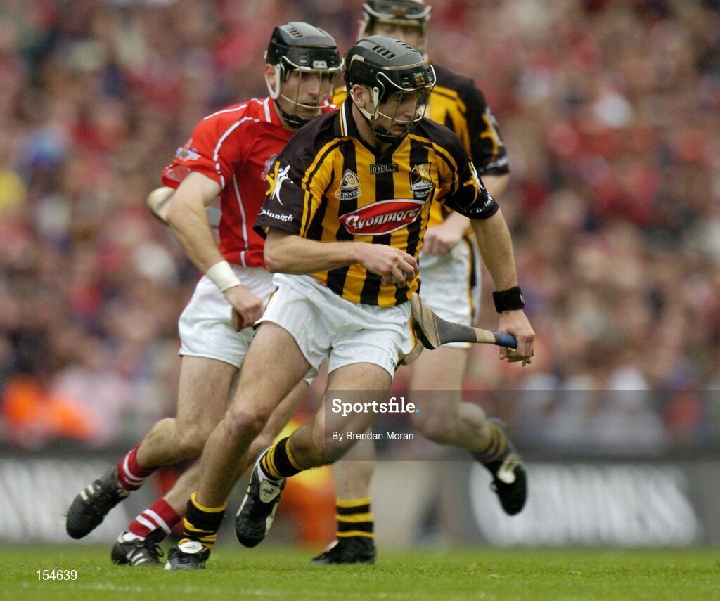 12 September 2004; JJ Delaney, Kilkenny, in action against Ben O'Connor, Cork. Guinness All-Ireland Senior Hurling Championship Final, Cork v Kilkenny, Croke Park, Dublin. Picture credit; Brendan Moran / SPORTSFILE *** Local Caption *** Any photograph taken by SPORTSFILE during, or in connection with, the 2004 Guinness All-Ireland Hurling Final which displays GAA logos or contains an image or part of an image of any GAA intellectual property, or, which contains images of a GAA player/players in their playing uniforms, may only be used for editorial and non-advertising purposes.  Use of photographs for advertising, as posters or for purchase separately is strictly prohibited unless prior written approval has been obtained from the Gaelic Athletic Association.