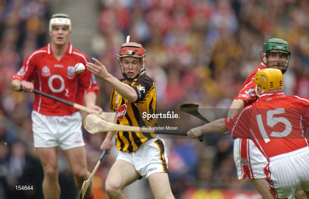 12 September 2004; Tommy Walsh, Kilkenny, in action against Niall McCarthy, left, Joe Deane (15) and Jerry O'Connor, Cork. Guinness All-Ireland Senior Hurling Championship Final, Cork v Kilkenny, Croke Park, Dublin. Picture credit; Brendan Moran / SPORTSFILE *** Local Caption *** Any photograph taken by SPORTSFILE during, or in connection with, the 2004 Guinness All-Ireland Hurling Final which displays GAA logos or contains an image or part of an image of any GAA intellectual property, or, which contains images of a GAA player/players in their playing uniforms, may only be used for editorial and non-advertising purposes.  Use of photographs for advertising, as posters or for purchase separately is strictly prohibited unless prior written approval has been obtained from the Gaelic Athletic Association.