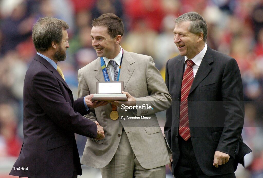 12 September 2004; President of the GAA Sean Kelly, makes a special presentation to Irish Olympic Gold Medallist Cian O'Connor, in the company of Liam Mulvihill, right, Ard Stiurthoir of the GAA, at half-time. Guinness All-Ireland Senior Hurling Championship Final, Cork v Kilkenny, Croke Park, Dublin. Picture credit; Brendan Moran / SPORTSFILE *** Local Caption *** Any photograph taken by SPORTSFILE during, or in connection with, the 2004 Guinness All-Ireland Hurling Final which displays GAA logos or contains an image or part of an image of any GAA intellectual property, or, which contains images of a GAA player/players in their playing uniforms, may only be used for editorial and non-advertising purposes.  Use of photographs for advertising, as posters or for purchase separately is strictly prohibited unless prior written approval has been obtained from the Gaelic Athletic Association.