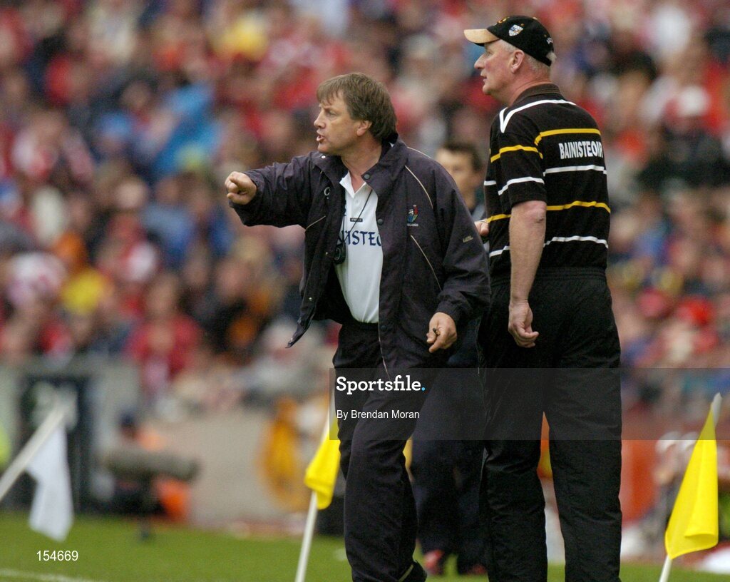 12 September 2004; Cork manager Donal O'Grady, left, and Kilkenny manager Brian Cody issue instructions to their respective teams. Guinness All-Ireland Senior Hurling Championship Final, Cork v Kilkenny, Croke Park, Dublin. Picture credit; Brendan Moran / SPORTSFILE *** Local Caption *** Any photograph taken by SPORTSFILE during, or in connection with, the 2004 Guinness All-Ireland Hurling Final which displays GAA logos or contains an image or part of an image of any GAA intellectual property, or, which contains images of a GAA player/players in their playing uniforms, may only be used for editorial and non-advertising purposes.  Use of photographs for advertising, as posters or for purchase separately is strictly prohibited unless prior written approval has been obtained from the Gaelic Athletic Association.