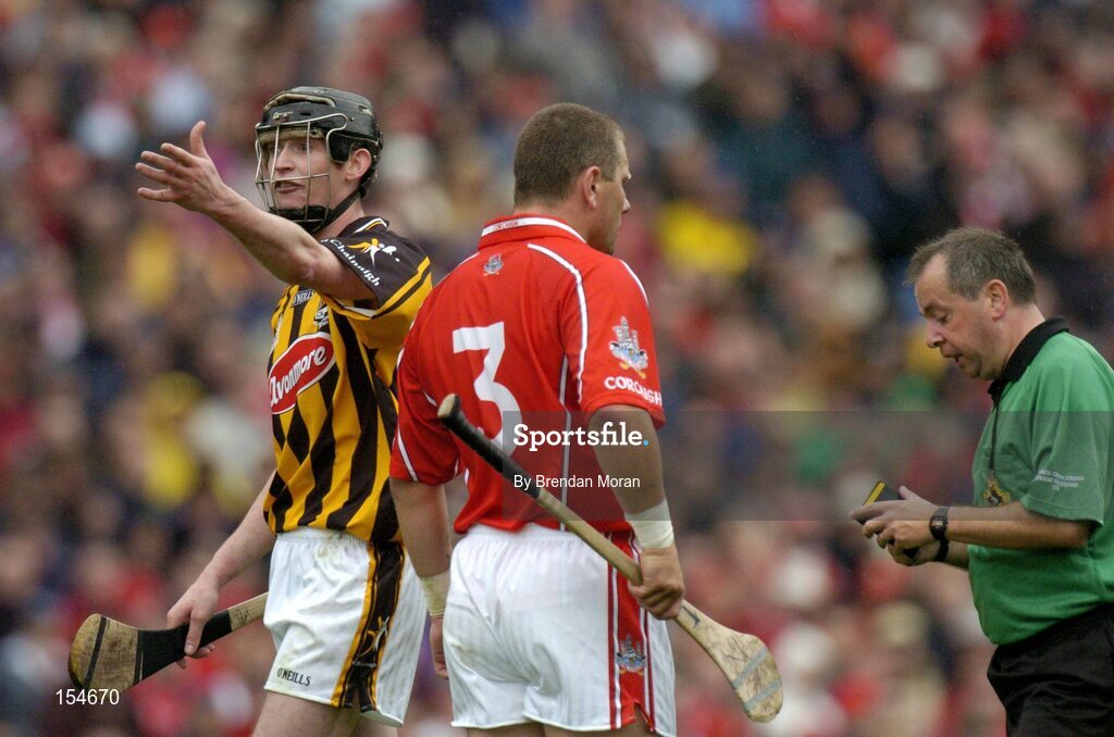 12 September 2004; Kilkenny's Martin Comerford makes a point to an umpire as Referee Aodan MacSuibhne has a word with Cork's Diarmuid O'Sullivan. Guinness All-Ireland Senior Hurling Championship Final, Cork v Kilkenny, Croke Park, Dublin. Picture credit; Brendan Moran / SPORTSFILE *** Local Caption *** Any photograph taken by SPORTSFILE during, or in connection with, the 2004 Guinness All-Ireland Hurling Final which displays GAA logos or contains an image or part of an image of any GAA intellectual property, or, which contains images of a GAA player/players in their playing uniforms, may only be used for editorial and non-advertising purposes.  Use of photographs for advertising, as posters or for purchase separately is strictly prohibited unless prior written approval has been obtained from the Gaelic Athletic Association.