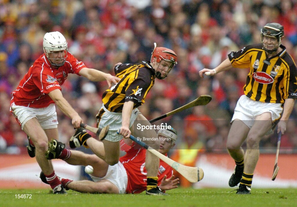 12 September 2004; Tommy Walsh and Peter Barry, right, Kilkenny, contest possession with Timmy McCarthy, left, and Niall McCarthy, Cork. Guinness All-Ireland Senior Hurling Championship Final, Cork v Kilkenny, Croke Park, Dublin. Picture credit; Brendan Moran / SPORTSFILE *** Local Caption *** Any photograph taken by SPORTSFILE during, or in connection with, the 2004 Guinness All-Ireland Hurling Final which displays GAA logos or contains an image or part of an image of any GAA intellectual property, or, which contains images of a GAA player/players in their playing uniforms, may only be used for editorial and non-advertising purposes.  Use of photographs for advertising, as posters or for purchase separately is strictly prohibited unless prior written approval has been obtained from the Gaelic Athletic Association.
