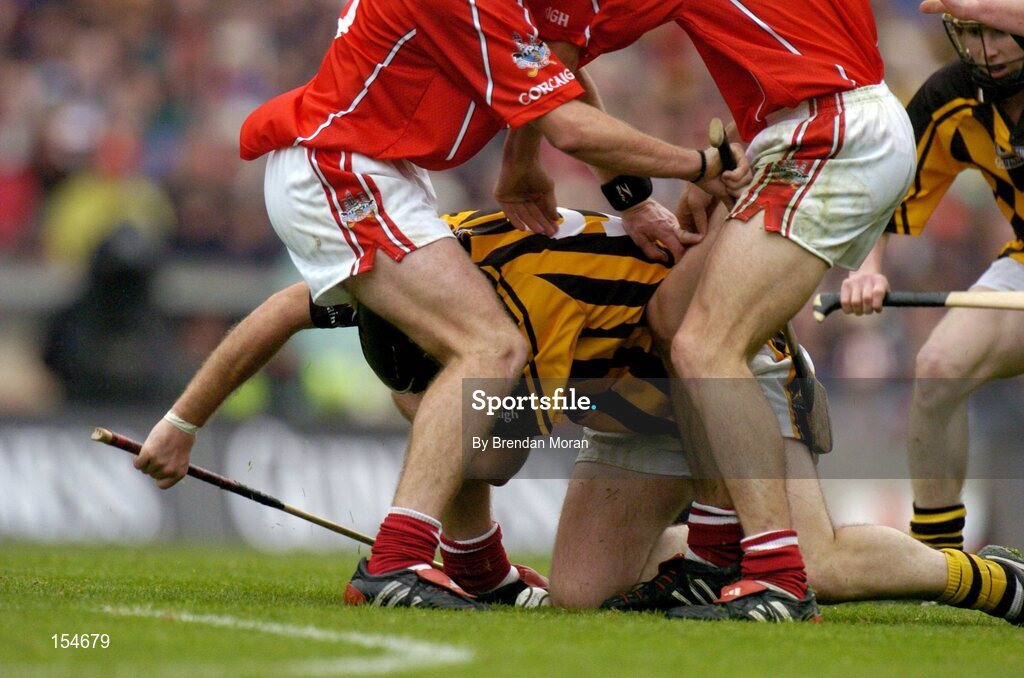 12 September 2004; Ken Coogan, Kilkenny, under pressure from Cork players. Guinness All-Ireland Senior Hurling Championship Final, Cork v Kilkenny, Croke Park, Dublin. Picture credit; Brendan Moran / SPORTSFILE *** Local Caption *** Any photograph taken by SPORTSFILE during, or in connection with, the 2004 Guinness All-Ireland Hurling Final which displays GAA logos or contains an image or part of an image of any GAA intellectual property, or, which contains images of a GAA player/players in their playing uniforms, may only be used for editorial and non-advertising purposes.  Use of photographs for advertising, as posters or for purchase separately is strictly prohibited unless prior written approval has been obtained from the Gaelic Athletic Association.