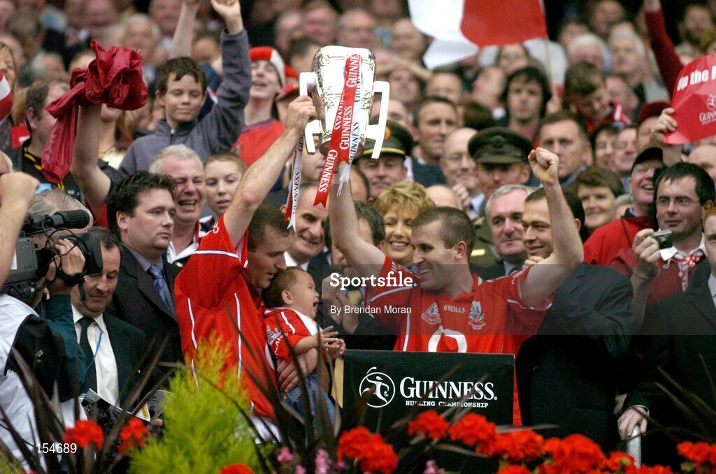 12 September 2004; Cork captain Ben O'Connor, right, with his brother and their niece Katie, lift the Liam MacCarthy cup after victory over Kilkenny. Guinness All-Ireland Senior Hurling Championship Final, Cork v Kilkenny, Croke Park, Dublin. Picture credit; Brendan Moran / SPORTSFILE *** Local Caption *** Any photograph taken by SPORTSFILE during, or in connection with, the 2004 Guinness All-Ireland Hurling Final which displays GAA logos or contains an image or part of an image of any GAA intellectual property, or, which contains images of a GAA player/players in their playing uniforms, may only be used for editorial and non-advertising purposes.  Use of photographs for advertising, as posters or for purchase separately is strictly prohibited unless prior written approval has been obtained from the Gaelic Athletic Association.