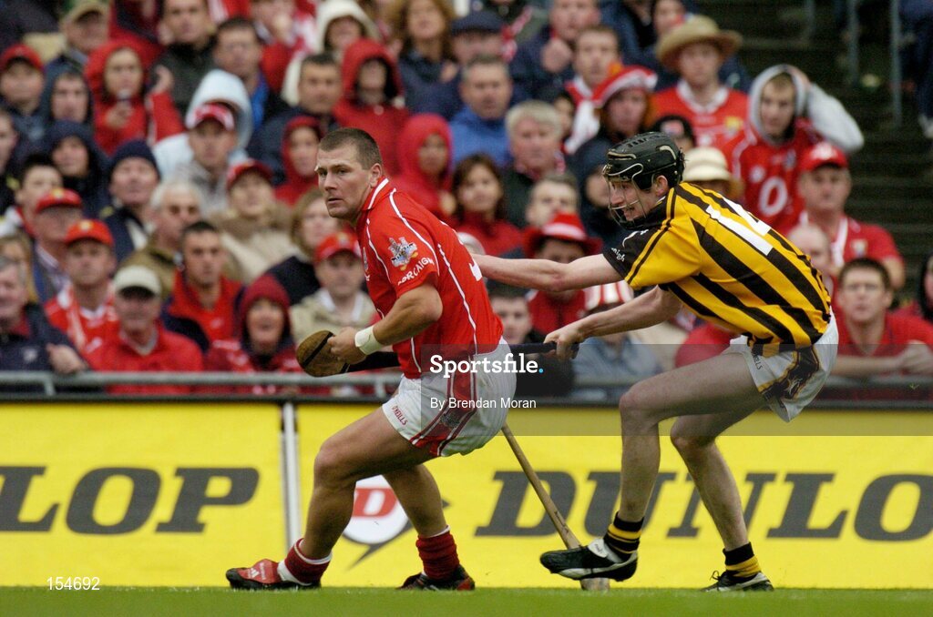 12 September 2004; Diarmuid O'Sullivan, Cork, in action against Martin Comerford, Kilkenny. Guinness All-Ireland Senior Hurling Championship Final, Cork v Kilkenny, Croke Park, Dublin. Picture credit; Brendan Moran / SPORTSFILE *** Local Caption *** Any photograph taken by SPORTSFILE during, or in connection with, the 2004 Guinness All-Ireland Hurling Final which displays GAA logos or contains an image or part of an image of any GAA intellectual property, or, which contains images of a GAA player/players in their playing uniforms, may only be used for editorial and non-advertising purposes.  Use of photographs for advertising, as posters or for purchase separately is strictly prohibited unless prior written approval has been obtained from the Gaelic Athletic Association.