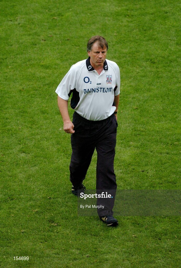 12 September 2004; Donal O'Grady, Cork manager, leaves the pitch before the game. Guinness All-Ireland Senior Hurling Championship Final, Cork v Kilkenny, Croke Park, Dublin. Picture credit; Pat Murphy / SPORTSFILE *** Local Caption *** Any photograph taken by SPORTSFILE during, or in connection with, the 2004 Guinness All-Ireland Hurling Final which displays GAA logos or contains an image or part of an image of any GAA intellectual property, or, which contains images of a GAA player/players in their playing uniforms, may only be used for editorial and non-advertising purposes.  Use of photographs for advertising, as posters or for purchase separately is strictly prohibited unless prior written approval has been obtained from the Gaelic Athletic Association.
