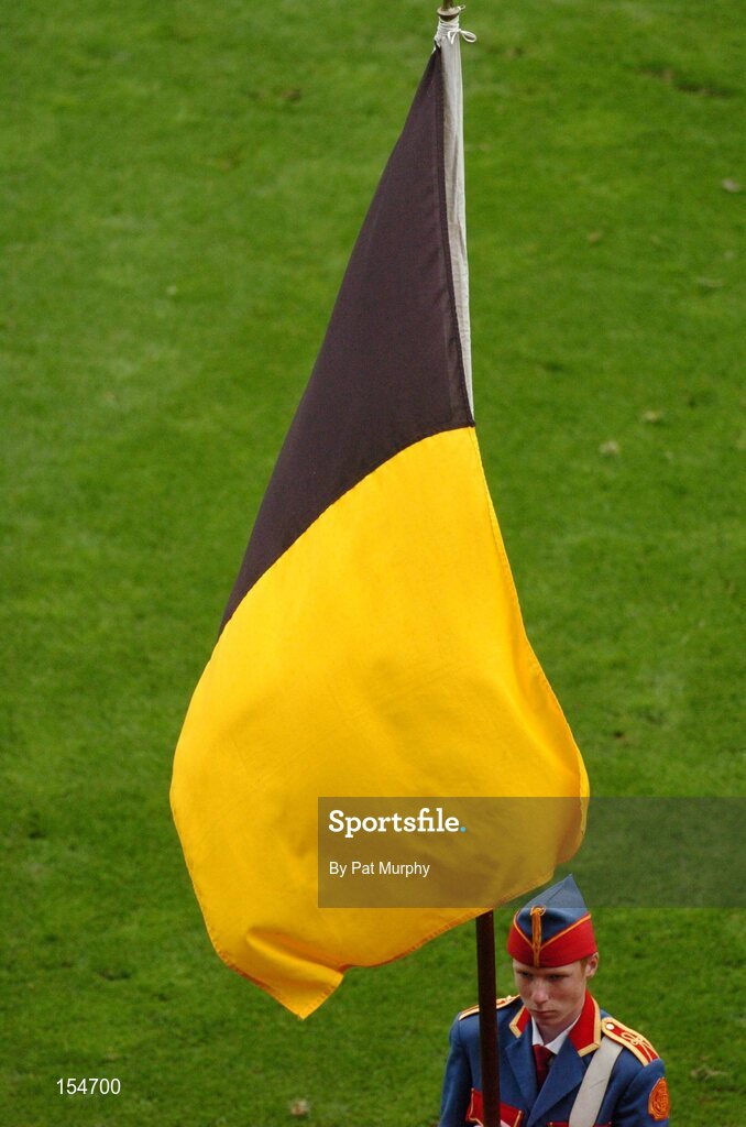 12 September 2004; A member of the Artane Boys Band holds the Kilkenny flag before the game. Kilkenny. Guinness All-Ireland Senior Hurling Championship Final, Cork v Kilkenny, Croke Park, Dublin. Picture credit; Pat Murphy / SPORTSFILE *** Local Caption *** Any photograph taken by SPORTSFILE during, or in connection with, the 2004 Guinness All-Ireland Hurling Final which displays GAA logos or contains an image or part of an image of any GAA intellectual property, or, which contains images of a GAA player/players in their playing uniforms, may only be used for editorial and non-advertising purposes.  Use of photographs for advertising, as posters or for purchase separately is strictly prohibited unless prior written approval has been obtained from the Gaelic Athletic Association.