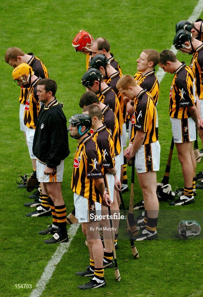 12 September 2004; The Kilkenny team stand for a minutes silence. Guinness All-Ireland Senior Hurling Championship Final, Cork v Kilkenny, Croke Park, Dublin. Picture credit; Pat Murphy / SPORTSFILE *** Local Caption *** Any photograph taken by SPORTSFILE during, or in connection with, the 2004 Guinness All-Ireland Hurling Final which displays GAA logos or contains an image or part of an image of any GAA intellectual property, or, which contains images of a GAA player/players in their playing uniforms, may only be used for editorial and non-advertising purposes.  Use of photographs for advertising, as posters or for purchase separately is strictly prohibited unless prior written approval has been obtained from the Gaelic Athletic Association.