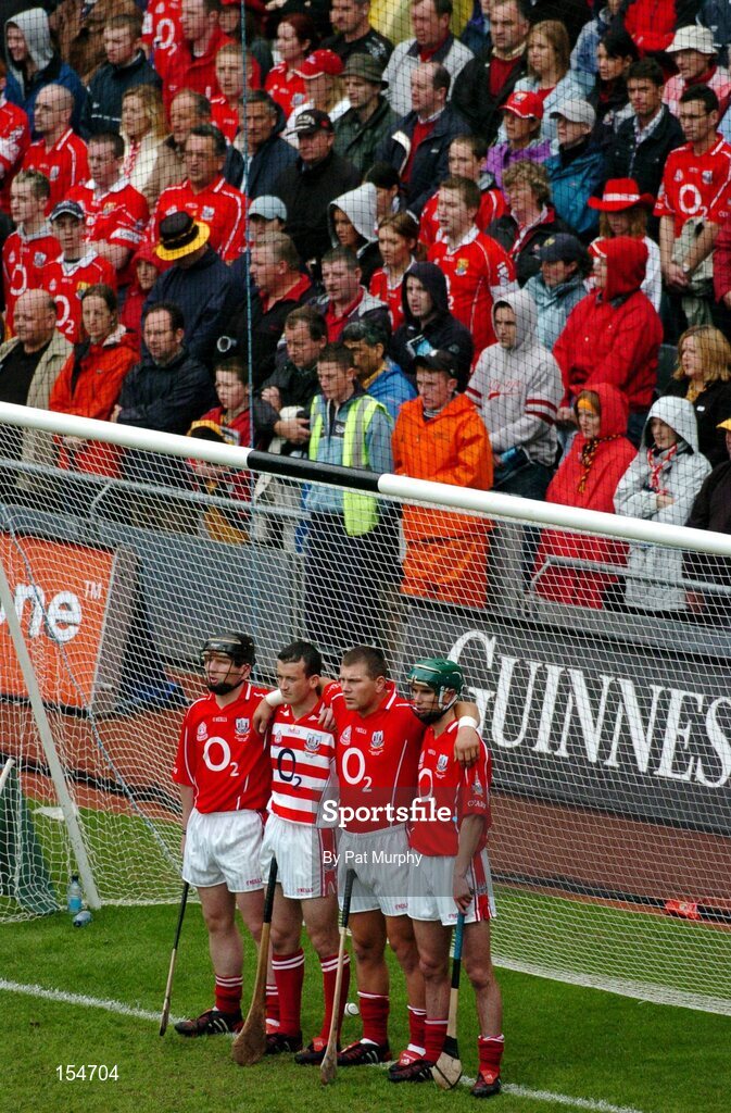 12 September 2004; Cork players and supporters stand for the National Anthem. Guinness All-Ireland Senior Hurling Championship Final, Cork v Kilkenny, Croke Park, Dublin. Picture credit; Pat Murphy / SPORTSFILE *** Local Caption *** Any photograph taken by SPORTSFILE during, or in connection with, the 2004 Guinness All-Ireland Hurling Final which displays GAA logos or contains an image or part of an image of any GAA intellectual property, or, which contains images of a GAA player/players in their playing uniforms, may only be used for editorial and non-advertising purposes.  Use of photographs for advertising, as posters or for purchase separately is strictly prohibited unless prior written approval has been obtained from the Gaelic Athletic Association.