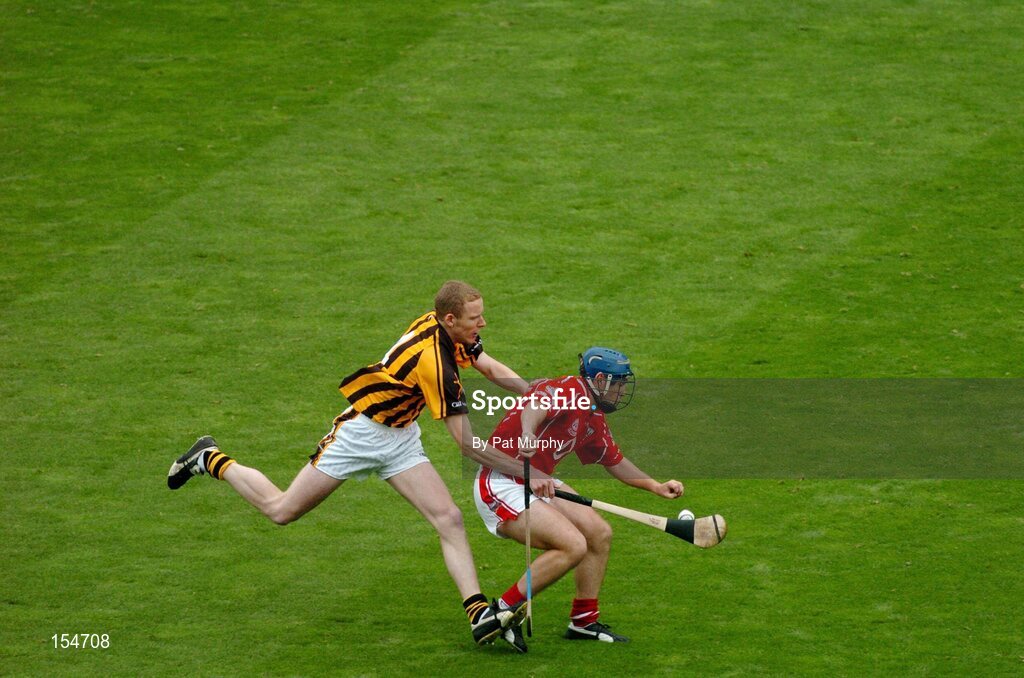 12 September 2004; Tom Kenny, Cork, in action against James Ryall, Kilkenny. Guinness All-Ireland Senior Hurling Championship Final, Cork v Kilkenny, Croke Park, Dublin. Picture credit; Pat Murphy / SPORTSFILE *** Local Caption *** Any photograph taken by SPORTSFILE during, or in connection with, the 2004 Guinness All-Ireland Hurling Final which displays GAA logos or contains an image or part of an image of any GAA intellectual property, or, which contains images of a GAA player/players in their playing uniforms, may only be used for editorial and non-advertising purposes.  Use of photographs for advertising, as posters or for purchase separately is strictly prohibited unless prior written approval has been obtained from the Gaelic Athletic Association.