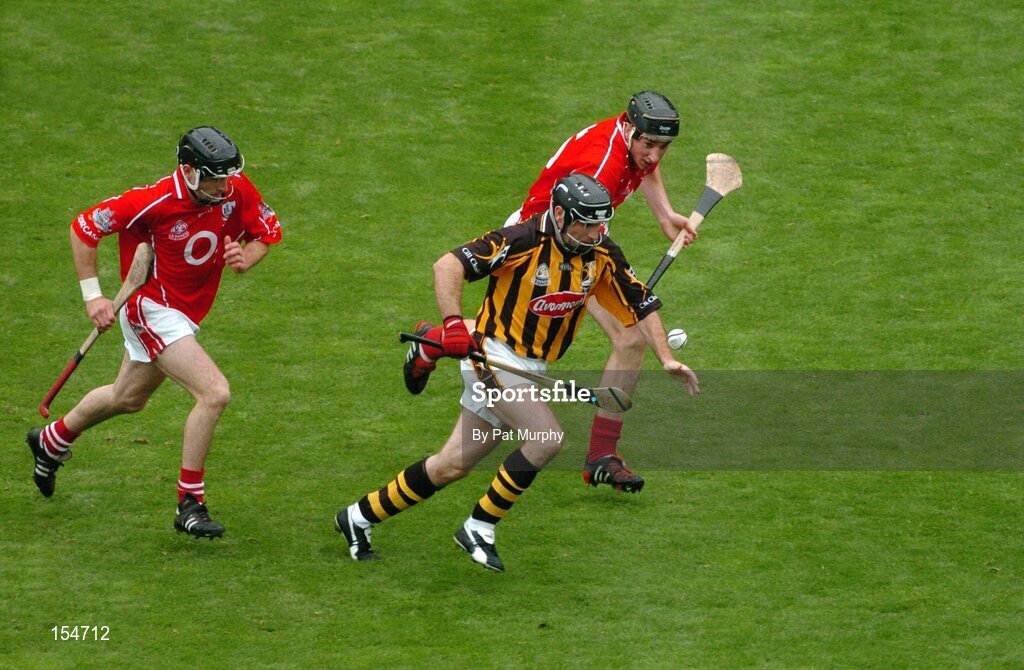 12 September 2004; DJ Carey, Kilkenny, in action against Cork's John Gardiner, right, and Ben O'Connor. Guinness All-Ireland Senior Hurling Championship Final, Cork v Kilkenny, Croke Park, Dublin. Picture credit; Pat Murphy / SPORTSFILE *** Local Caption *** Any photograph taken by SPORTSFILE during, or in connection with, the 2004 Guinness All-Ireland Hurling Final which displays GAA logos or contains an image or part of an image of any GAA intellectual property, or, which contains images of a GAA player/players in their playing uniforms, may only be used for editorial and non-advertising purposes.  Use of photographs for advertising, as posters or for purchase separately is strictly prohibited unless prior written approval has been obtained from the Gaelic Athletic Association.