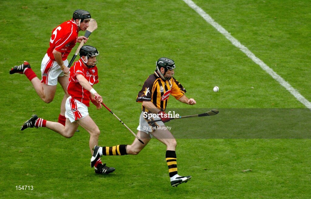 12 September 2004; DJ Carey, Kilkenny, in action against Ben O'Connor and John Gardiner, top, Cork. Guinness All-Ireland Senior Hurling Championship Final, Cork v Kilkenny, Croke Park, Dublin. Picture credit; Pat Murphy / SPORTSFILE *** Local Caption *** Any photograph taken by SPORTSFILE during, or in connection with, the 2004 Guinness All-Ireland Hurling Final which displays GAA logos or contains an image or part of an image of any GAA intellectual property, or, which contains images of a GAA player/players in their playing uniforms, may only be used for editorial and non-advertising purposes.  Use of photographs for advertising, as posters or for purchase separately is strictly prohibited unless prior written approval has been obtained from the Gaelic Athletic Association.