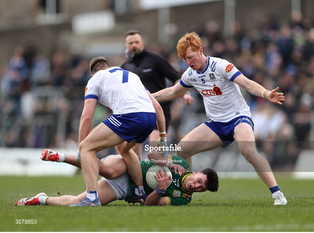16 March 2025; Keith Curtis of Meath is tackled by Ciarán Caulfield, left, and Ryan O'Toole of Monaghan during the Allianz Football League Division 2 match between Meath and Monaghan at Páirc Tailteann in Navan, Meath. Photo by Thomas Flinkow/Sportsfile