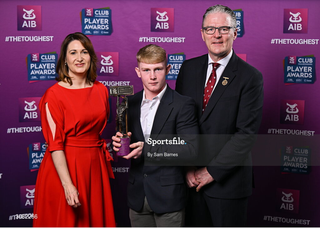 21 March 2025; Slaughtneil hurler Fionn McEldowney is presented with his 2024/25 Hurling Team of the Year award by Uachtarán Cumann Lúthchleas Gael, Jarlath Burns and Chief Customer Officer of AIB, Orlaith Ryan during the AIB Club Player Awards at Croke Park in Dublin. The AIB Club Player Awards celebrated the best players from club Football, Hurling, Camogie, and LGFA in a single ceremony for the first time, recognising their outstanding achievements on the field throughout the season. Photo by Sam Barnes/Sportsfile
