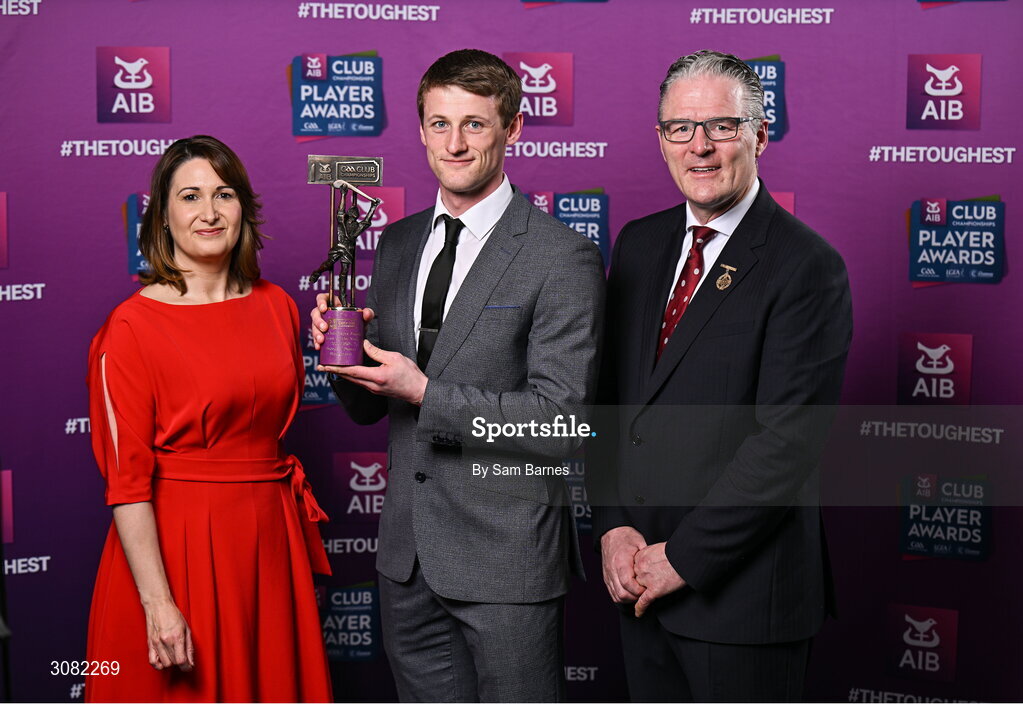 21 March 2025; Slaughtneil hurler Brendan Rogers is presented with his 2024/25 Hurling Team of the Year award by Uachtarán Cumann Lúthchleas Gael, Jarlath Burns and Chief Customer Officer of AIB, Orlaith Ryan during the AIB Club Player Awards at Croke Park in Dublin. The AIB Club Player Awards celebrated the best players from club Football, Hurling, Camogie, and LGFA in a single ceremony for the first time, recognising their outstanding achievements on the field throughout the season. Photo by Sam Barnes/Sportsfile