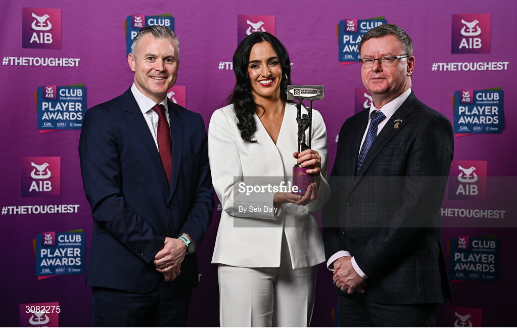 21 March 2025; Sarsfields camogie player Niamh McGrath is presented her 2024 Camogie Team of the Year award by Uachtarán an Cumann Camógaíochta, Brian Molloy, right, and Chief Marketing Officer of AIB, Mark Doyle during the AIB Club Player Awards at Croke Park in Dublin. The AIB Club Player Awards celebrated the best players from club Football, Hurling, Camogie, and LGFA in a single ceremony for the first time, recognising their outstanding achievements on the field throughout the season. Photo by Seb Daly/Sportsfile