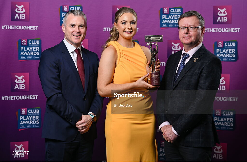 21 March 2025; Sarsfields camogie player Maria Cooney is presented her 2024 Camogie Team of the Year award by Uachtarán an Cumann Camógaíochta, Brian Molloy, right, and Chief Marketing Officer of AIB, Mark Doyle during the AIB Club Player Awards at Croke Park in Dublin. The AIB Club Player Awards celebrated the best players from club Football, Hurling, Camogie, and LGFA in a single ceremony for the first time, recognising their outstanding achievements on the field throughout the season. Photo by Seb Daly/Sportsfile
