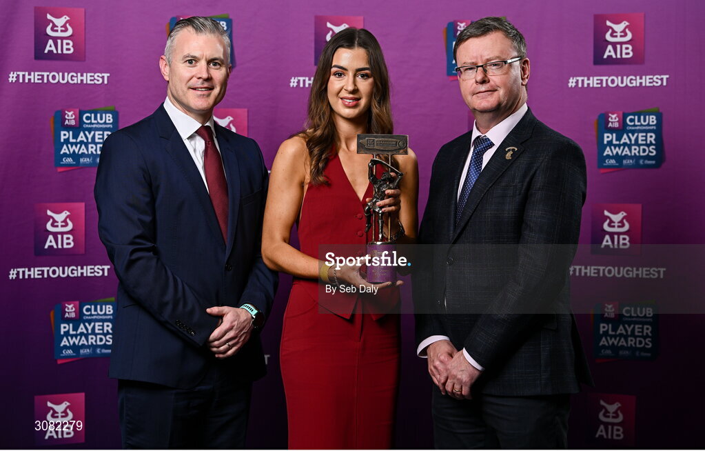 21 March 2025; Sarsfields camogie player Klara Donohue is presented her 2024 Camogie Team of the Year award by Uachtarán an Cumann Camógaíochta, Brian Molloy, right, and Chief Marketing Officer of AIB, Mark Doyle during the AIB Club Player Awards at Croke Park in Dublin. The AIB Club Player Awards celebrated the best players from club Football, Hurling, Camogie, and LGFA in a single ceremony for the first time, recognising their outstanding achievements on the field throughout the season. Photo by Seb Daly/Sportsfile