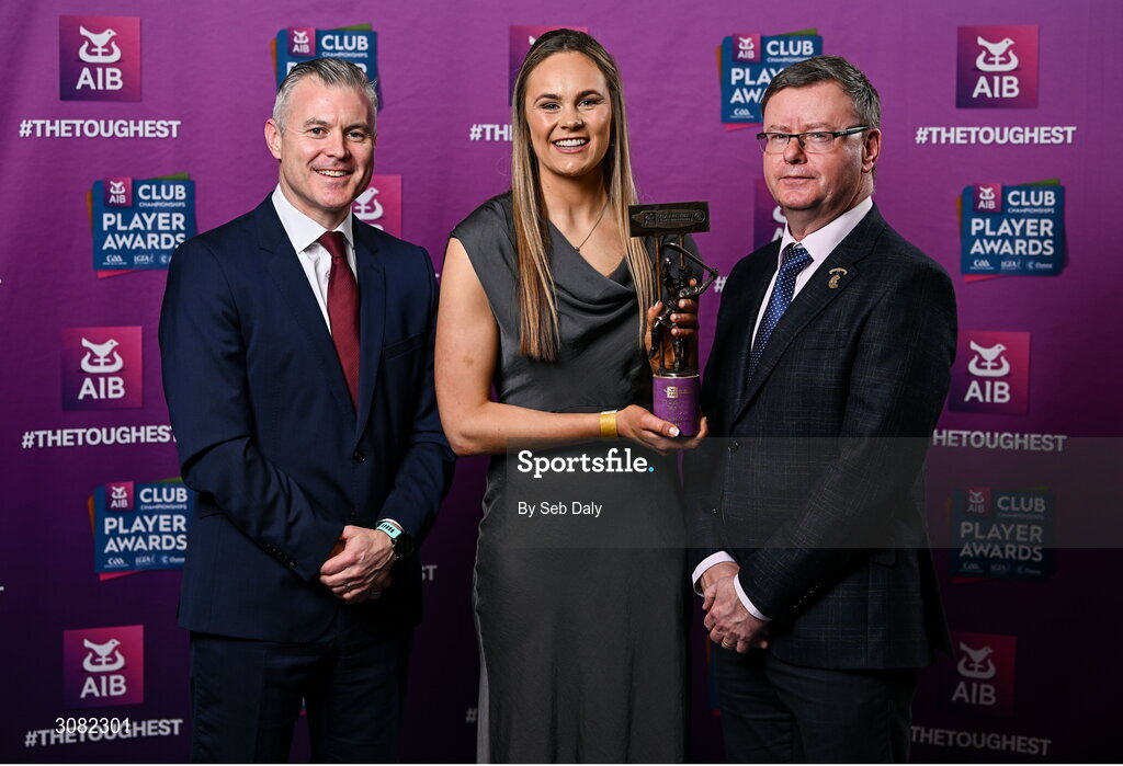 21 March 2025; Truagh Clonlara camogie player Aine O'Loughlin is presented her 2024 Camogie Team of the Year award by Uachtarán an Cumann Camógaíochta, Brian Molloy, right, and Chief Marketing Officer of AIB, Mark Doyle during the AIB Club Player Awards at Croke Park in Dublin. The AIB Club Player Awards celebrated the best players from club Football, Hurling, Camogie, and LGFA in a single ceremony for the first time, recognising their outstanding achievements on the field throughout the season. Photo by Seb Daly/Sportsfile
