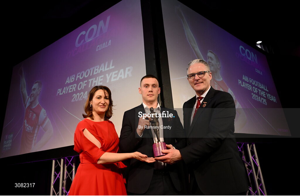 21 March 2025; Con O’Callaghan of Cuala is presented with his 2024/25 AIB GAA Club Football Player of the Year award by Uachtarán Cumann Lúthchleas Gael Jarlath Burns and AIB Chief Customer Officer Orlaith Ryan during the AIB Club Player Awards at Croke Park in Dublin. The AIB Club Player Awards celebrated the best players from club Football, Hurling, Camogie, and LGFA in a single ceremony for the first time, recognising their outstanding achievements on the field throughout the season. Photo by Ramsey Cardy/Sportsfile