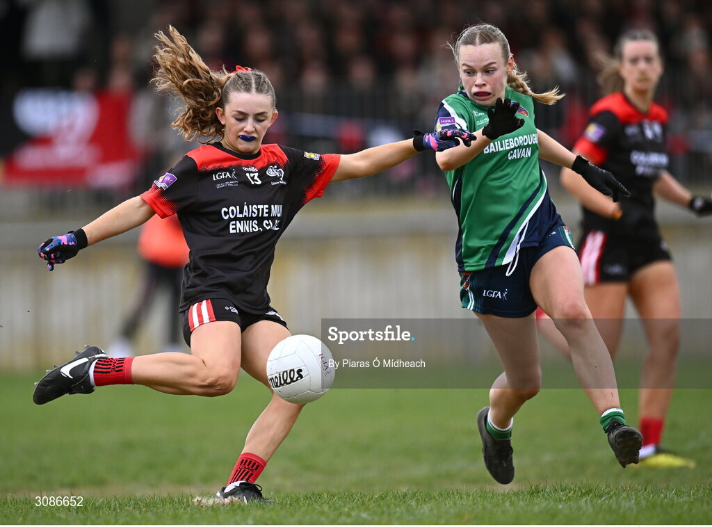 26 March 2025; Kate Jones of Coláiste Muire Ennis shoots under pressure from Ella Banville of Bailieborough Community School during the Lidl LGFA PPS All-Ireland Senior C final match between Bailieborough Community School of Cavan and Coláiste Muire of Clare at Geraldine Park in Athy, Kildare. Photo by Piaras Ó Mídheach/Sportsfile