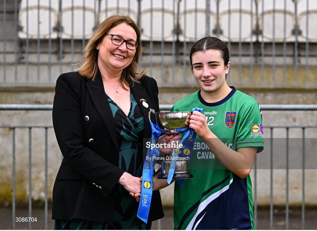 26 March 2025; Bailieborough Community School captain Ella Sheridan receives the cup from LGFA President Trina Murray after her side's victory in the Lidl LGFA PPS All-Ireland Senior C final match between Bailieborough Community School of Cavan and Coláiste Muire of Clare at Geraldine Park in Athy, Kildare. Photo by Piaras Ó Mídheach/Sportsfile