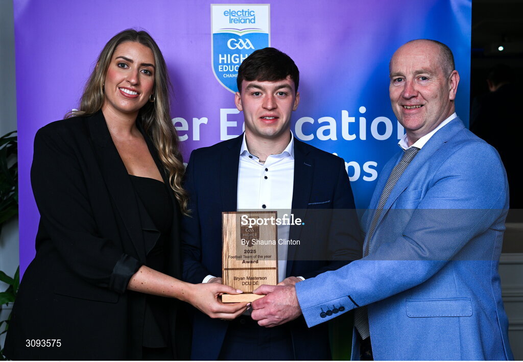 31 March 2025; DCU Dóchas  Éireann player Bryan Masterson, centre, is presented with his 2025 Electric Ireland Higher Education GAA Football Rising Stars Team of the Year award by Electric Ireland Sponsorship Manager Sarah Gelletlie, left, and Higher Education GAA Chairperson Benny Hurl during the Electric Ireland Higher Education Rising Stars Awards at Castleknock Hotel in Dublin. Photo by Shauna Clinton/Sportsfile