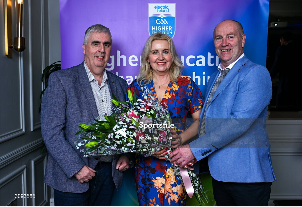 31 March 2025; Caroline Tully, wife of Higher Education Committee Chairman Gerry Tully, left, is presented with flowers by Higher Education GAA Chairperson Benny Hurl during the Electric Ireland Higher Education Rising Stars Awards at Castleknock Hotel in Dublin. Photo by Shauna Clinton/Sportsfile