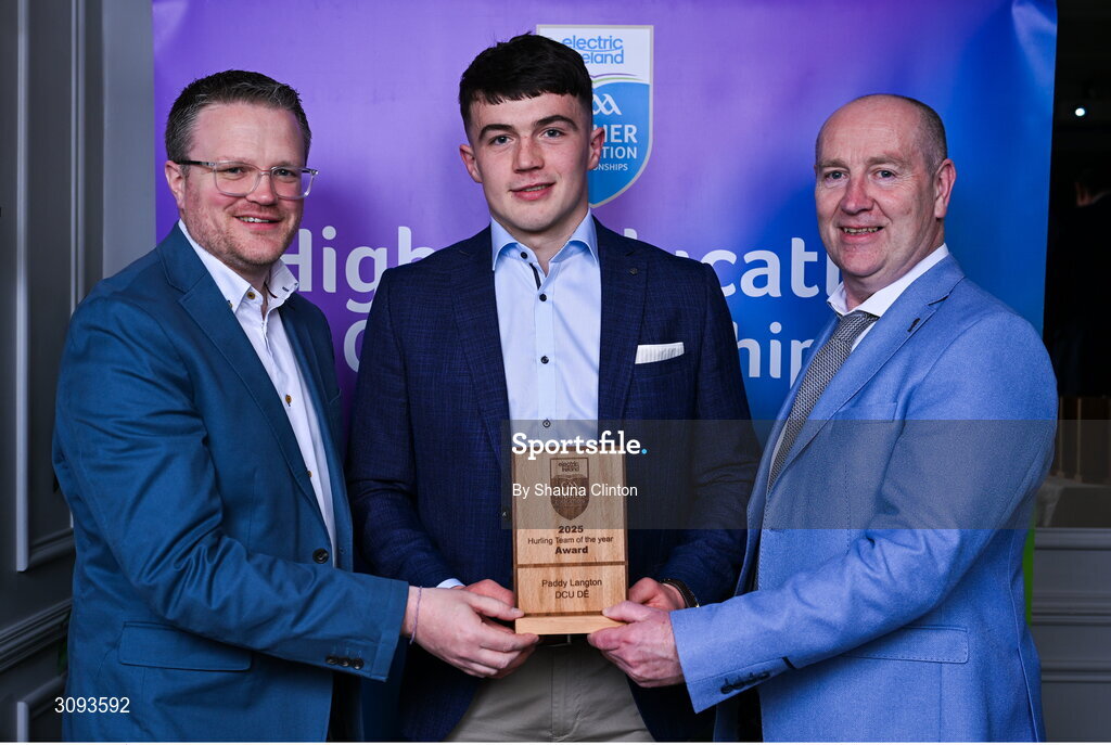 31 March 2025; DCU Dóchas Éireann player Paddy Langton, centre, is presented with his 2025 Electric Ireland Higher Education GAA Hurling Rising Stars Team of the Year award by Electric Ireland Group Sponsorship & PR Manager Rob Crabbe, left, and Higher Education GAA Chairperson Benny Hurl during the Electric Ireland Higher Education Rising Stars Awards at Castleknock Hotel in Dublin. Photo by Shauna Clinton/Sportsfile