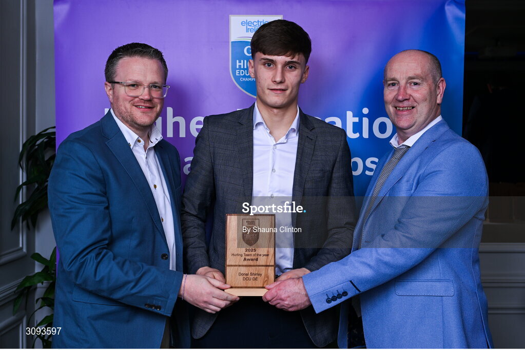 31 March 2025; DCU Dóchas Éireann player Donal Shirley, centre, is presented with his 2025 Electric Ireland Higher Education GAA Hurling Rising Stars Team of the Year award by Electric Ireland Group Sponsorship & PR Manager Rob Crabbe, left, and Higher Education GAA Chairperson Benny Hurl during the Electric Ireland Higher Education Rising Stars Awards at Castleknock Hotel in Dublin. Photo by Shauna Clinton/Sportsfile