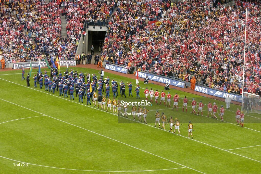 12 September 2004; The Cork and Kilkenny players parade behind the Artane Boys Band in front of the Canal End. Guinness All-Ireland Senior Hurling Championship Final, Cork v Kilkenny, Croke Park, Dublin. Picture credit; Pat Murphy / SPORTSFILE *** Local Caption *** Any photograph taken by SPORTSFILE during, or in connection with, the 2004 Guinness All-Ireland Hurling Final which displays GAA logos or contains an image or part of an image of any GAA intellectual property, or, which contains images of a GAA player/players in their playing uniforms, may only be used for editorial and non-advertising purposes.  Use of photographs for advertising, as posters or for purchase separately is strictly prohibited unless prior written approval has been obtained from the Gaelic Athletic Association.