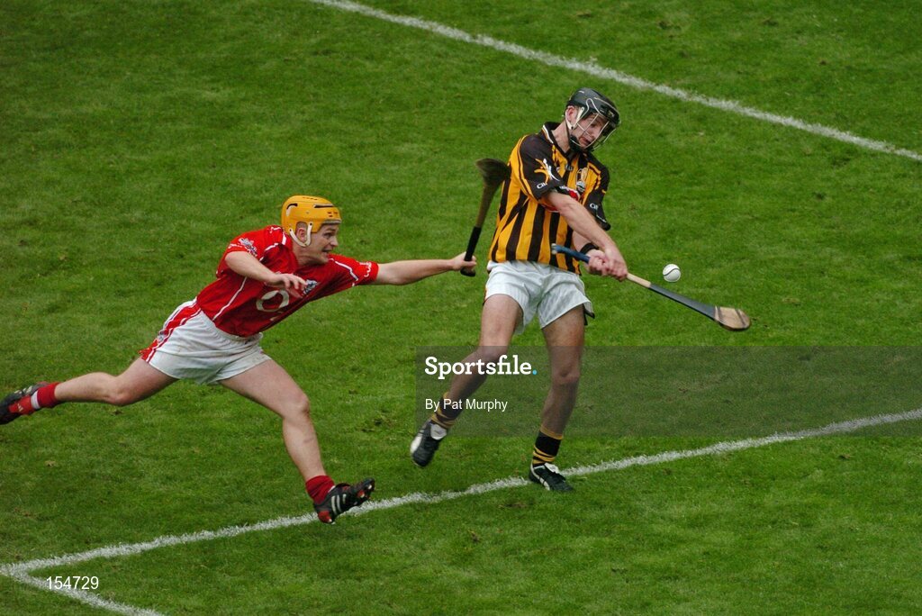 12 September 2004; J.J. Delaney, Kilkenny, in action against Joe Deane, Cork. Guinness All-Ireland Senior Hurling Championship Final, Cork v Kilkenny, Croke Park, Dublin. Picture credit; Pat Murphy / SPORTSFILE *** Local Caption *** Any photograph taken by SPORTSFILE during, or in connection with, the 2004 Guinness All-Ireland Hurling Final which displays GAA logos or contains an image or part of an image of any GAA intellectual property, or, which contains images of a GAA player/players in their playing uniforms, may only be used for editorial and non-advertising purposes.  Use of photographs for advertising, as posters or for purchase separately is strictly prohibited unless prior written approval has been obtained from the Gaelic Athletic Association.