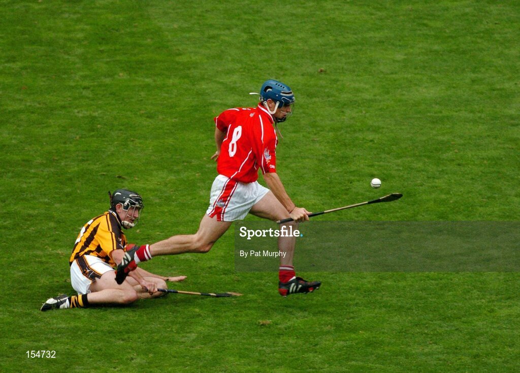 12 September 2004; Tom Kenny, Cork, goes past the challenge of Tommy Walsh, Kilkenny. Guinness All-Ireland Senior Hurling Championship Final, Cork v Kilkenny, Croke Park, Dublin. Picture credit; Pat Murphy / SPORTSFILE *** Local Caption *** Any photograph taken by SPORTSFILE during, or in connection with, the 2004 Guinness All-Ireland Hurling Final which displays GAA logos or contains an image or part of an image of any GAA intellectual property, or, which contains images of a GAA player/players in their playing uniforms, may only be used for editorial and non-advertising purposes.  Use of photographs for advertising, as posters or for purchase separately is strictly prohibited unless prior written approval has been obtained from the Gaelic Athletic Association.