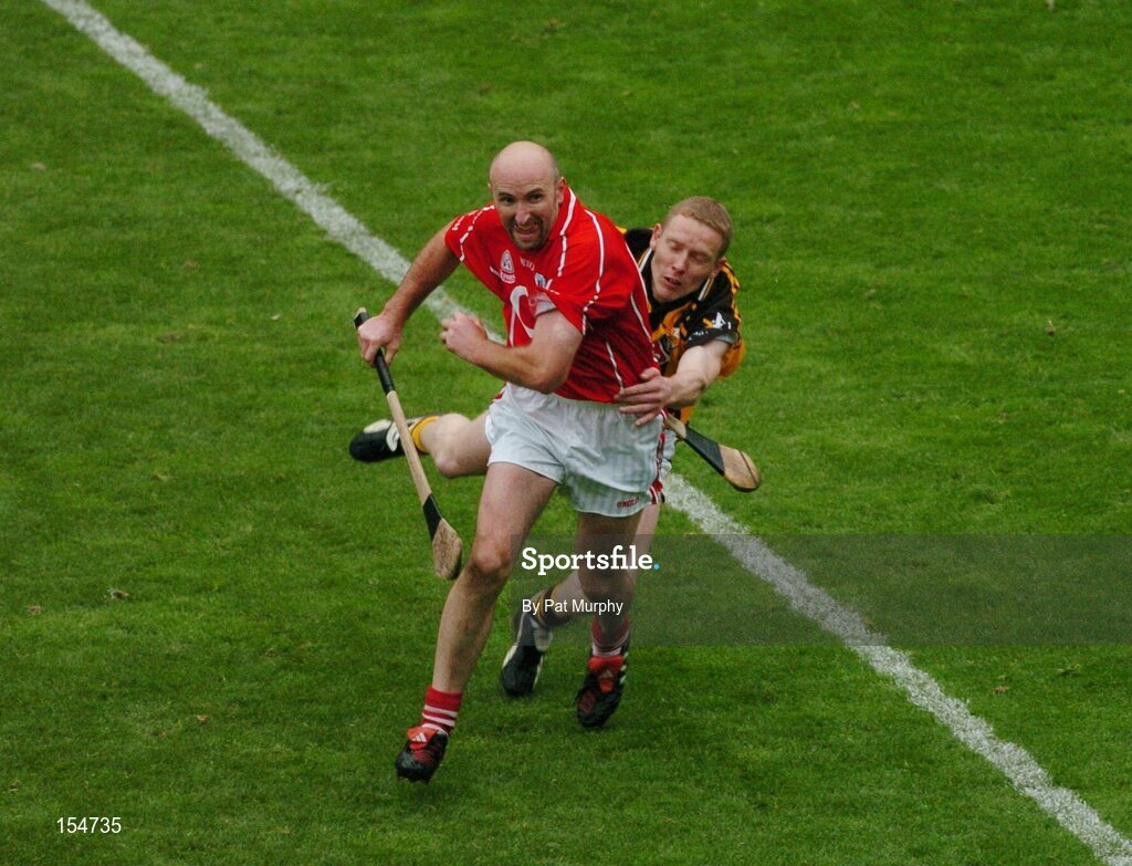 12 September 2004; Brian Corcoran, Cork, in action against James Ryall, Kilkenny. Guinness All-Ireland Senior Hurling Championship Final, Cork v Kilkenny, Croke Park, Dublin. Picture credit; Pat Murphy / SPORTSFILE *** Local Caption *** Any photograph taken by SPORTSFILE during, or in connection with, the 2004 Guinness All-Ireland Hurling Final which displays GAA logos or contains an image or part of an image of any GAA intellectual property, or, which contains images of a GAA player/players in their playing uniforms, may only be used for editorial and non-advertising purposes.  Use of photographs for advertising, as posters or for purchase separately is strictly prohibited unless prior written approval has been obtained from the Gaelic Athletic Association.