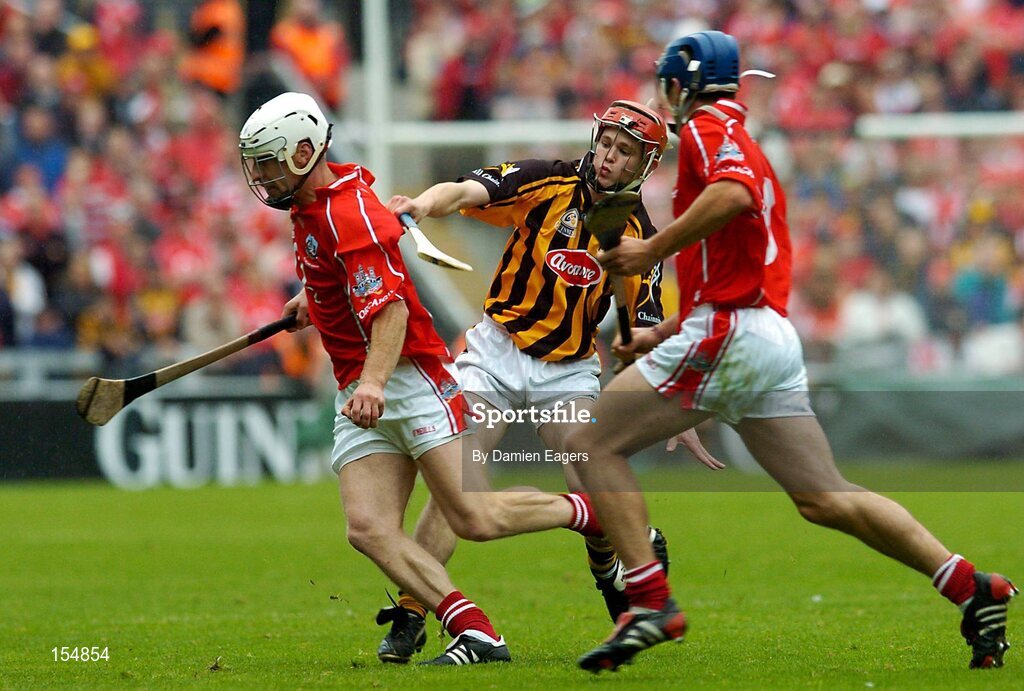 12 September 2004; Timmy McCarthy, Cork, in action against Tommy Walsh, Kilkenny, supported by team-mate Tom Kenny. Guinness All-Ireland Senior Hurling Championship Final, Cork v Kilkenny, Croke Park, Dublin. Picture credit; Damien Eagers / SPORTSFILE *** Local Caption *** Any photograph taken by SPORTSFILE during, or in connection with, the 2004 Guinness All-Ireland Hurling Final which displays GAA logos or contains an image or part of an image of any GAA intellectual property, or, which contains images of a GAA player/players in their playing uniforms, may only be used for editorial and non-advertising purposes.  Use of photographs for advertising, as posters or for purchase separately is strictly prohibited unless prior written approval has been obtained from the Gaelic Athletic Association.
