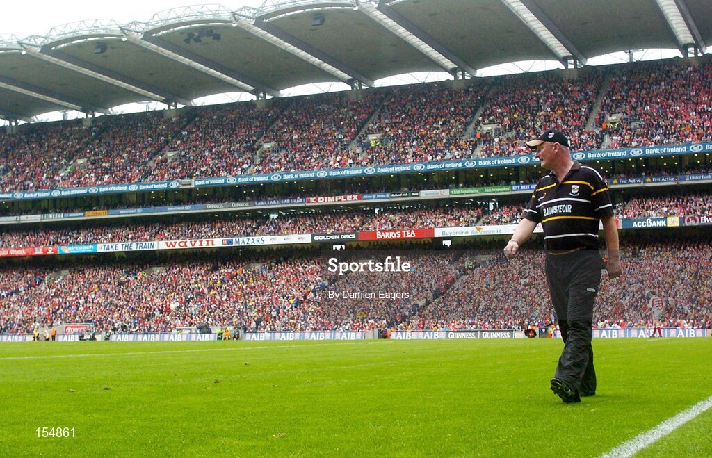 12 September 2004; Kilkenny manager Brian Cody walks the field during the match. Guinness All-Ireland Senior Hurling Championship Final, Cork v Kilkenny, Croke Park, Dublin. Picture credit; Damien Eagers / SPORTSFILE *** Local Caption *** Any photograph taken by SPORTSFILE during, or in connection with, the 2004 Guinness All-Ireland Hurling Final which displays GAA logos or contains an image or part of an image of any GAA intellectual property, or, which contains images of a GAA player/players in their playing uniforms, may only be used for editorial and non-advertising purposes.  Use of photographs for advertising, as posters or for purchase separately is strictly prohibited unless prior written approval has been obtained from the Gaelic Athletic Association.