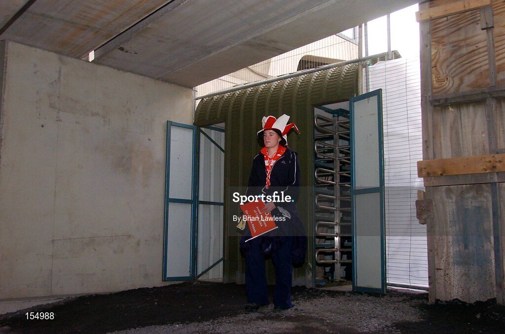 12 September 2004; A Cork fan makes her way to the new Nally stand. Guinness All-Ireland Senior Hurling Championship Final, Cork v Kilkenny, Croke Park, Dublin. Picture credit; Brian Lawless / SPORTSFILE *** Local Caption *** Any photograph taken by SPORTSFILE during, or in connection with, the 2004 Guinness All-Ireland Hurling Final which displays GAA logos or contains an image or part of an image of any GAA intellectual property, or, which contains images of a GAA player/players in their playing uniforms, may only be used for editorial and non-advertising purposes.  Use of photographs for advertising, as posters or for purchase separately is strictly prohibited unless prior written approval has been obtained from the Gaelic Athletic Association.