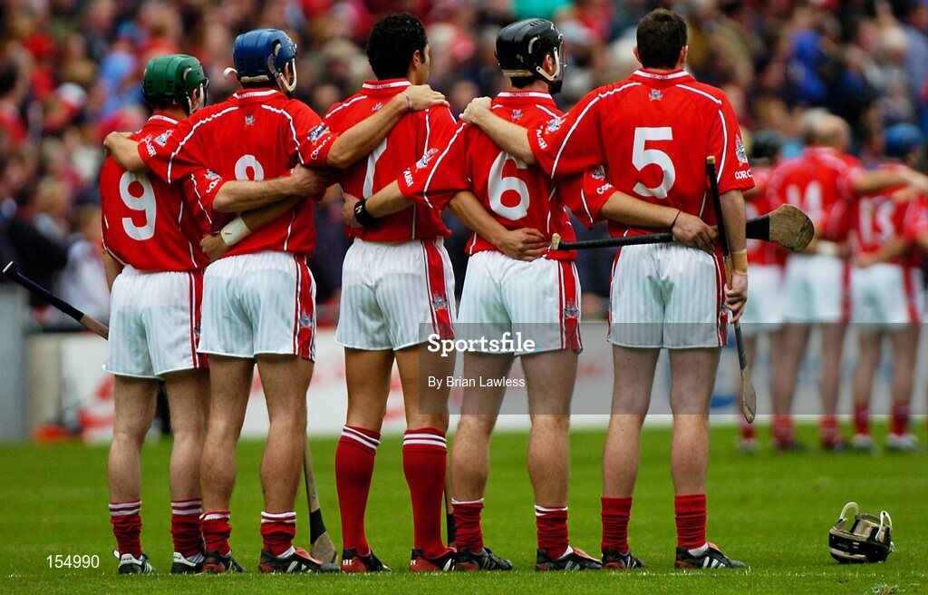 12 September 2004; Cork players stand for the National Anthem. Guinness All-Ireland Senior Hurling Championship Final, Cork v Kilkenny, Croke Park, Dublin. Picture credit; Brian Lawless / SPORTSFILE *** Local Caption *** Any photograph taken by SPORTSFILE during, or in connection with, the 2004 Guinness All-Ireland Hurling Final which displays GAA logos or contains an image or part of an image of any GAA intellectual property, or, which contains images of a GAA player/players in their playing uniforms, may only be used for editorial and non-advertising purposes.  Use of photographs for advertising, as posters or for purchase separately is strictly prohibited unless prior written approval has been obtained from the Gaelic Athletic Association.