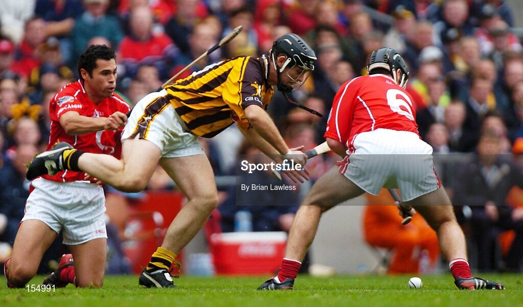 12 September 2004; Ken Coogan, Kilkenny, in action against Sean Og O hAilpin and Ronan Curan (6), Cork. Guinness All-Ireland Senior Hurling Championship Final, Cork v Kilkenny, Croke Park, Dublin. Picture credit; Brian Lawless / SPORTSFILE *** Local Caption *** Any photograph taken by SPORTSFILE during, or in connection with, the 2004 Guinness All-Ireland Hurling Final which displays GAA logos or contains an image or part of an image of any GAA intellectual property, or, which contains images of a GAA player/players in their playing uniforms, may only be used for editorial and non-advertising purposes.  Use of photographs for advertising, as posters or for purchase separately is strictly prohibited unless prior written approval has been obtained from the Gaelic Athletic Association.