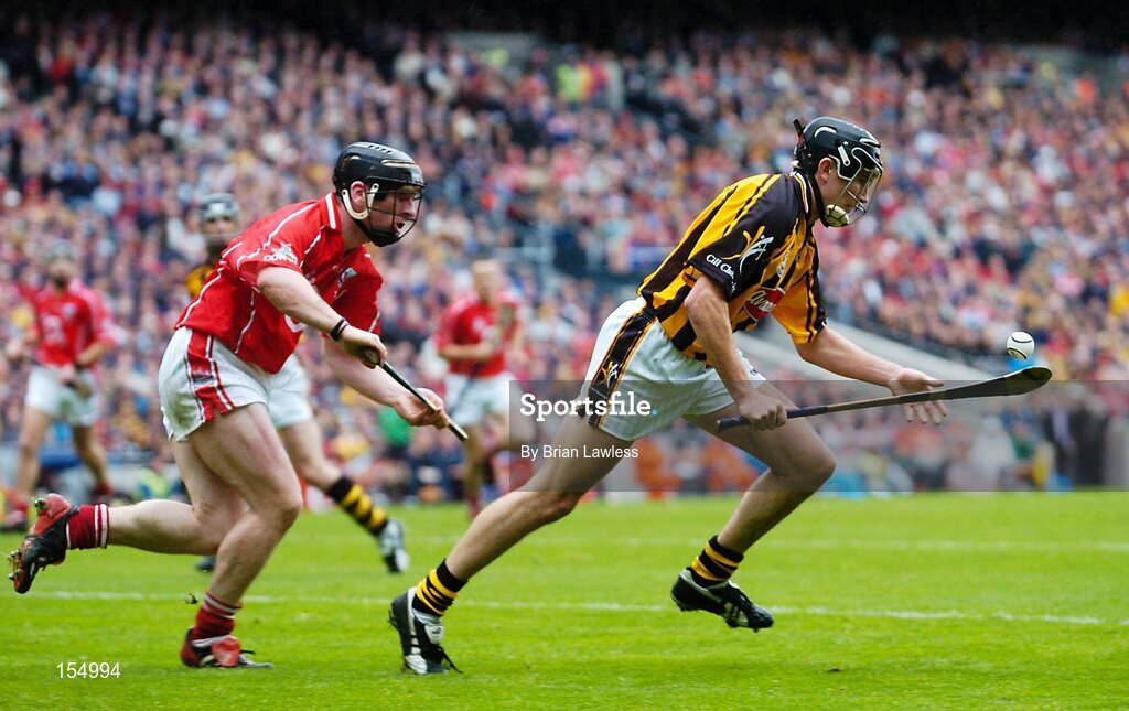 12 September 2004; Eddie Brennan, Kilkenny, in action against Wayne Sherlock, Cork. Guinness All-Ireland Senior Hurling Championship Final, Cork v Kilkenny, Croke Park, Dublin. Picture credit; Brian Lawless / SPORTSFILE *** Local Caption *** Any photograph taken by SPORTSFILE during, or in connection with, the 2004 Guinness All-Ireland Hurling Final which displays GAA logos or contains an image or part of an image of any GAA intellectual property, or, which contains images of a GAA player/players in their playing uniforms, may only be used for editorial and non-advertising purposes.  Use of photographs for advertising, as posters or for purchase separately is strictly prohibited unless prior written approval has been obtained from the Gaelic Athletic Association.