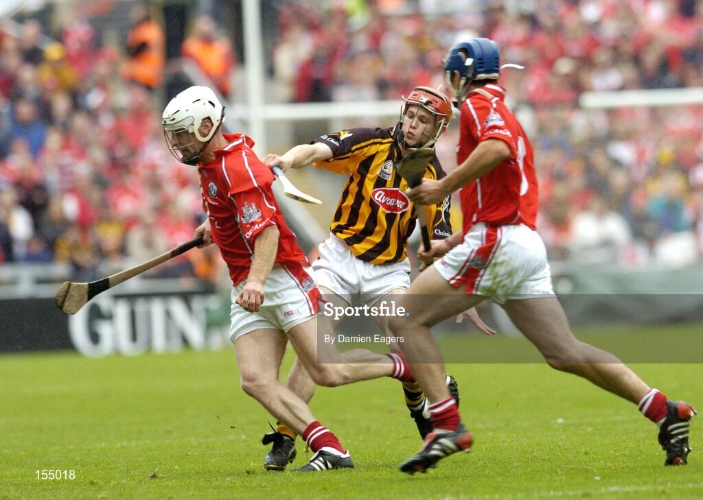12 September 2004; Timmy McCarthy, Cork, in action against Tommy Walsh, Kilkenny, supported by team-mate Tom Kenny. Guinness All-Ireland Senior Hurling Championship Final, Cork v Kilkenny, Croke Park, Dublin. Picture credit; Damien Eagers / SPORTSFILE *** Local Caption *** Any photograph taken by SPORTSFILE during, or in connection with, the 2004 Guinness All-Ireland Hurling Final which displays GAA logos or contains an image or part of an image of any GAA intellectual property, or, which contains images of a GAA player/players in their playing uniforms, may only be used for editorial and non-advertising purposes.  Use of photographs for advertising, as posters or for purchase separately is strictly prohibited unless prior written approval has been obtained from the Gaelic Athletic Association.