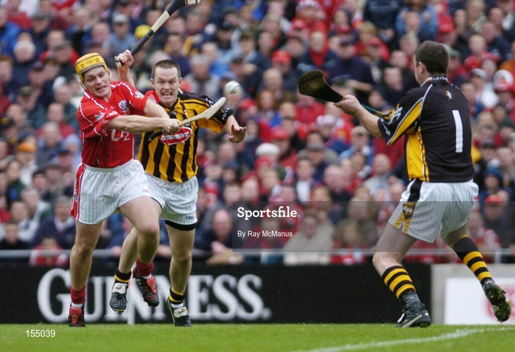 12 September 2004; Joe Deane, Cork, gets his shot away despite the attentions of Kilkenny's Michael Kavanagh, left and goalkeerer James McGarry. Guinness All-Ireland Senior Hurling Championship Final, Cork v Kilkenny, Croke Park, Dublin. Picture credit; Ray McManus / SPORTSFILE *** Local Caption *** Any photograph taken by SPORTSFILE during, or in connection with, the 2004 Guinness All-Ireland Hurling Final which displays GAA logos or contains an image or part of an image of any GAA intellectual property, or, which contains images of a GAA player/players in their playing uniforms, may only be used for editorial and non-advertising purposes.  Use of photographs for advertising, as posters or for purchase separately is strictly prohibited unless prior written approval has been obtained from the Gaelic Athletic Association.