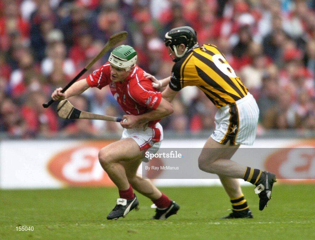 12 September 2004; Niall McCarthy, Cork, in action against Peter Barry, Kilkenny. Guinness All-Ireland Senior Hurling Championship Final, Cork v Kilkenny, Croke Park, Dublin. Picture credit; Ray McManus / SPORTSFILE *** Local Caption *** Any photograph taken by SPORTSFILE during, or in connection with, the 2004 Guinness All-Ireland Hurling Final which displays GAA logos or contains an image or part of an image of any GAA intellectual property, or, which contains images of a GAA player/players in their playing uniforms, may only be used for editorial and non-advertising purposes.  Use of photographs for advertising, as posters or for purchase separately is strictly prohibited unless prior written approval has been obtained from the Gaelic Athletic Association.