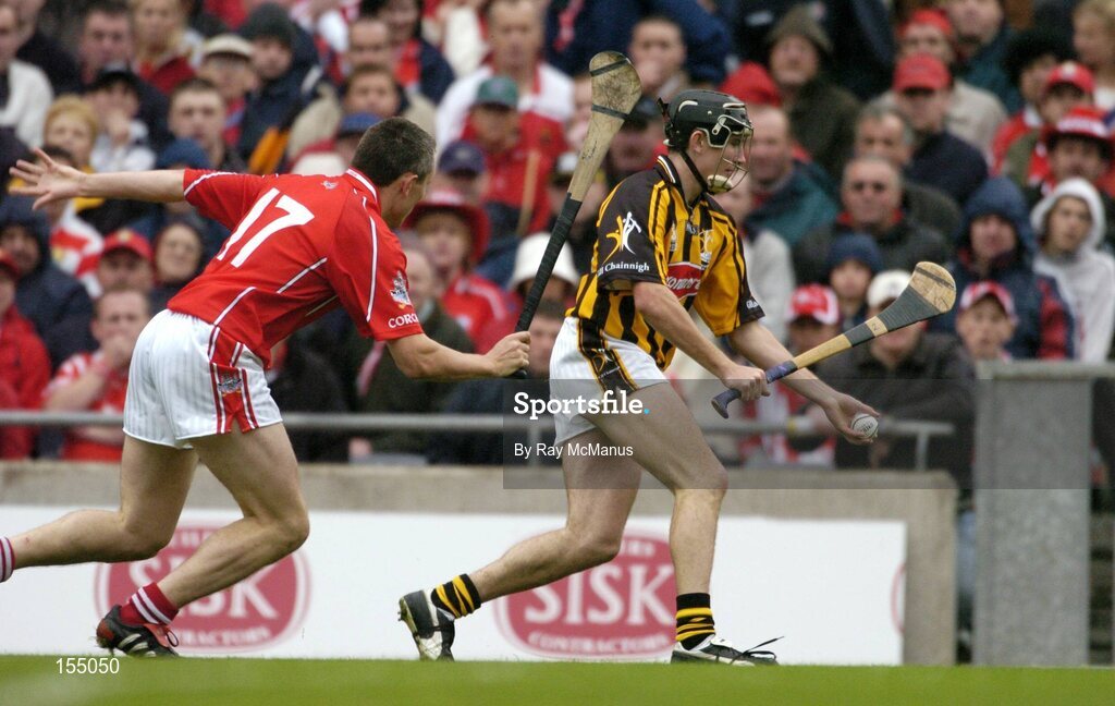 12 September 2004; Eddie Brennan, Kilkenny, in action against John Browne, Cork. Guinness All-Ireland Senior Hurling Championship Final, Cork v Kilkenny, Croke Park, Dublin. Picture credit; Ray McManus / SPORTSFILE *** Local Caption *** Any photograph taken by SPORTSFILE during, or in connection with, the 2004 Guinness All-Ireland Hurling Final which displays GAA logos or contains an image or part of an image of any GAA intellectual property, or, which contains images of a GAA player/players in their playing uniforms, may only be used for editorial and non-advertising purposes.  Use of photographs for advertising, as posters or for purchase separately is strictly prohibited unless prior written approval has been obtained from the Gaelic Athletic Association.