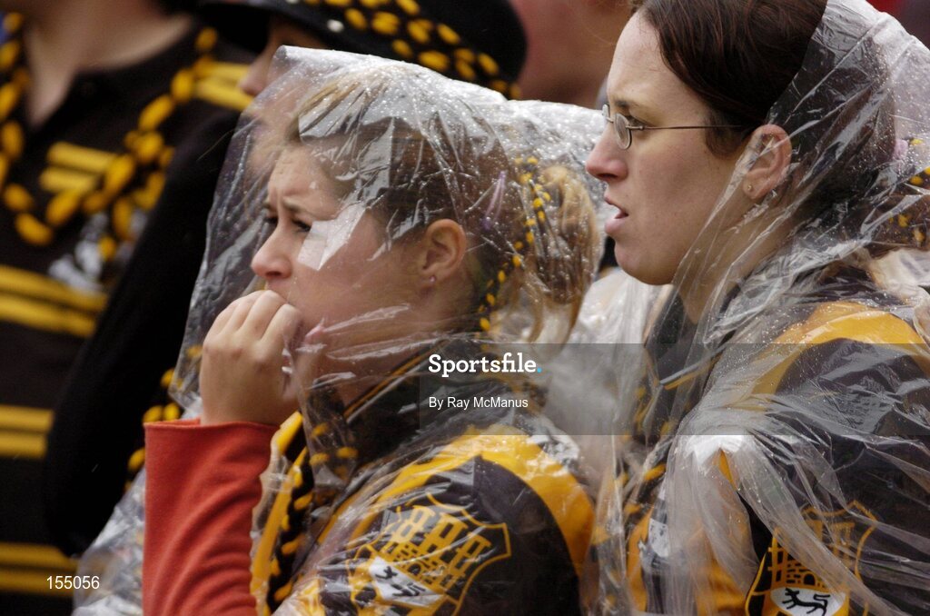 12 September 2004; Kilkenny fans shelter from the rain during the final stages of the game. Guinness All-Ireland Senior Hurling Championship Final, Cork v Kilkenny, Croke Park, Dublin. Picture credit; Ray McManus / SPORTSFILE *** Local Caption *** Any photograph taken by SPORTSFILE during, or in connection with, the 2004 Guinness All-Ireland Hurling Final which displays GAA logos or contains an image or part of an image of any GAA intellectual property, or, which contains images of a GAA player/players in their playing uniforms, may only be used for editorial and non-advertising purposes.  Use of photographs for advertising, as posters or for purchase separately is strictly prohibited unless prior written approval has been obtained from the Gaelic Athletic Association.